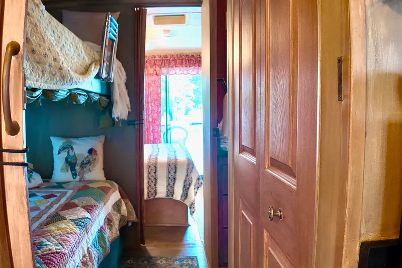 Slide: The Image of Interior of 1996 Catamaran Cruisers Aqua Cruiser 44 with cozy bunk beds and colorful decor. - 16