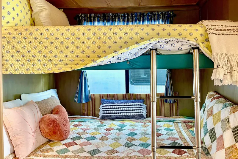Slide: The Image of Cozy bunk beds with colorful quilts in a 1996 Catamaran Cruisers Aqua Cruiser 44. - 17