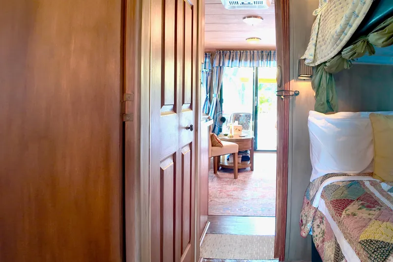 Slide: The Image of Interior of 1996 Catamaran Cruisers Aqua Cruiser 44, featuring cozy bedroom and living area. - 18