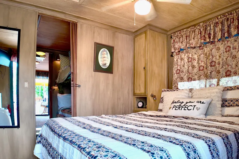 Slide: The Image of Cozy bedroom in 1996 Catamaran Cruisers Aqua Cruiser 44 with floral decor and striped bedding. - 21