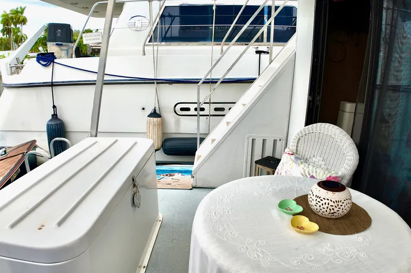 Slide: The Image of 1996 Catamaran Cruisers Aqua Cruiser 44 deck with table, chairs, and stairs. - 24