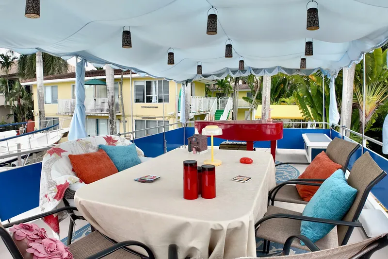 Slide: The Image of 1996 Catamaran Cruisers Aqua Cruiser 44 deck with table, chairs, and colorful decor. - 26