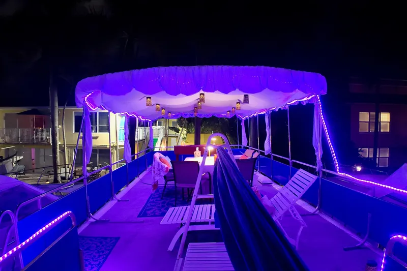 Slide: The Image of 1996 Catamaran Cruisers Aqua Cruiser 44 deck illuminated with purple lights at night. - 3