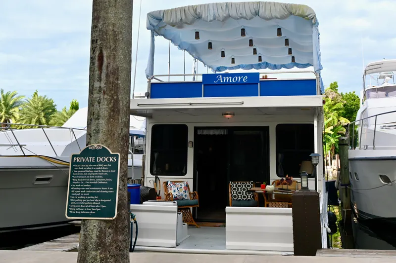 Slide: The Image of 1996 Catamaran Cruisers Aqua Cruiser 44 docked, featuring outdoor seating and canopy. - 35