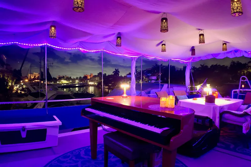 Slide: The Image of Luxurious 1996 Catamaran Cruisers Aqua Cruiser 44 with elegant interior lighting and piano. - 42