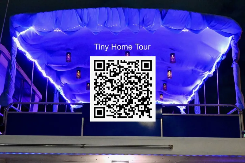 Slide: The Image of 1996 Catamaran Cruisers Aqua Cruiser 44 with illuminated canopy and QR code for tiny home tour. - 44