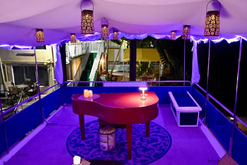 Slide: The Image of Luxurious 1996 Catamaran Cruisers Aqua Cruiser 44 interior with elegant lighting and piano. - 5