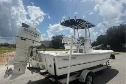 Slide: The Image of 2017 Twin Vee Power Cat boat with Suzuki outboard motor on trailer under cloudy sky. - 3