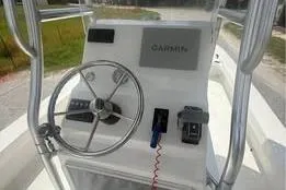 Slide: The Image of 2017 Twin Vee Power Cat boat console with Garmin navigation system and steering wheel. - 5