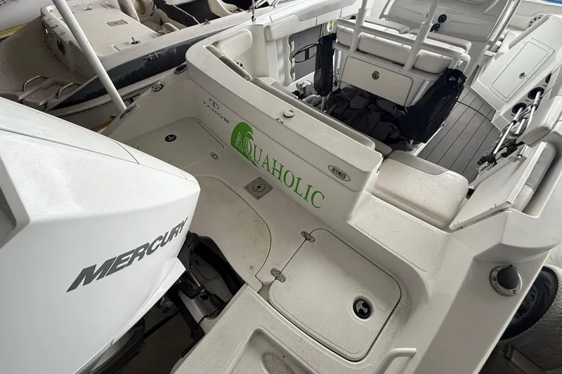 Slide: The Image of 2019 Tahoe 2150 CC boat interior with Mercury engine and "Aquaholic" decal. - 11