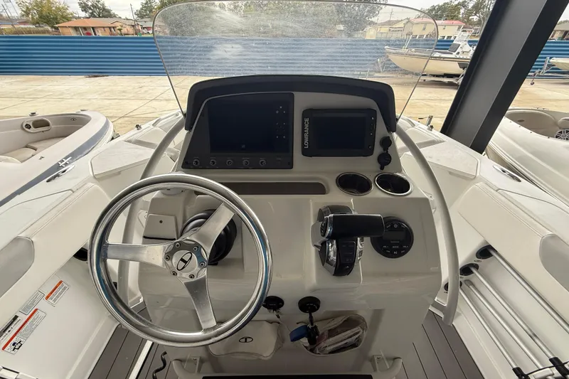 Slide: The Image of 2019 Tahoe 2150 CC boat dashboard with steering wheel and navigation controls. - 9