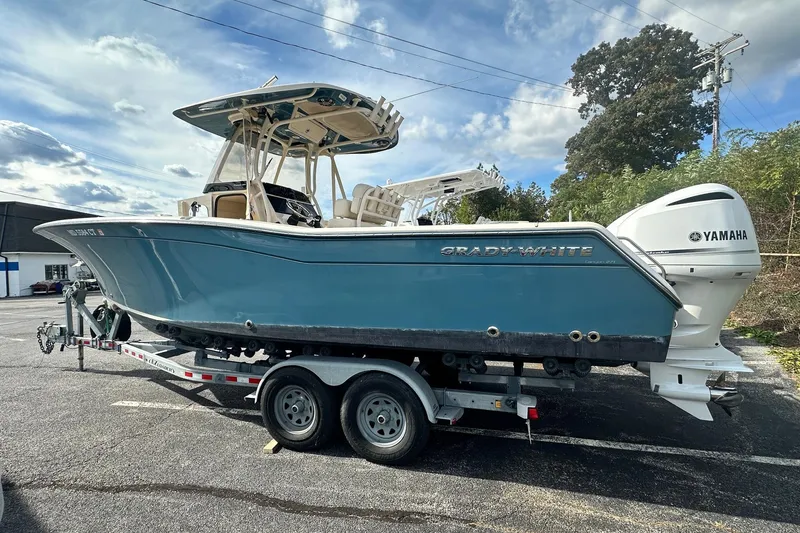 The Image of 2020 Grady-White Canyon 271 boat on trailer with Yamaha engine, parked outdoors. - 0
