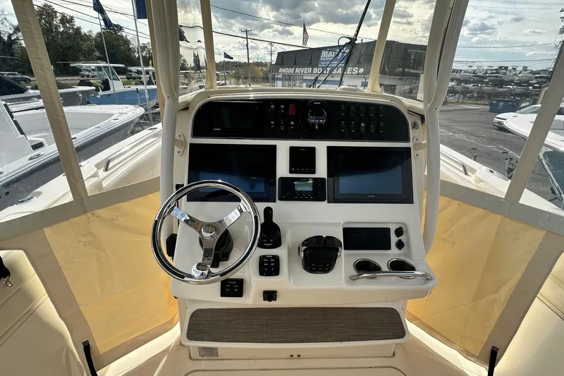 Slide: The Image of Helm of 2020 Grady-White Canyon 271 boat with steering wheel and navigation controls. - 16
