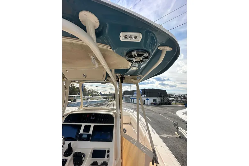 Slide: The Image of 2020 Grady-White Canyon 271 boat interior with modern dashboard and overhead speakers. - 19