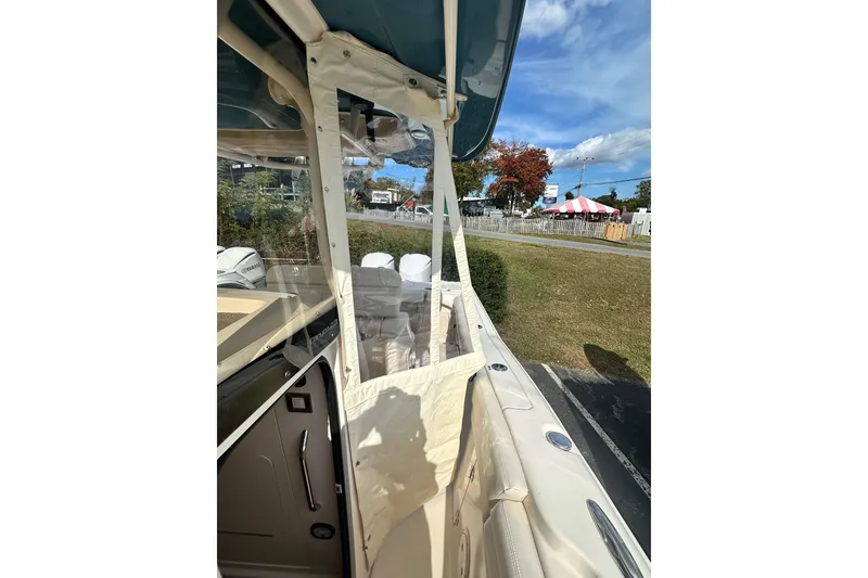 Slide: The Image of 2020 Grady-White Canyon 271 boat interior with clear enclosure and scenic outdoor view. - 21