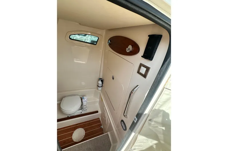Slide: The Image of 2020 Grady-White Canyon 271 boat interior with compact bathroom amenities. - 24