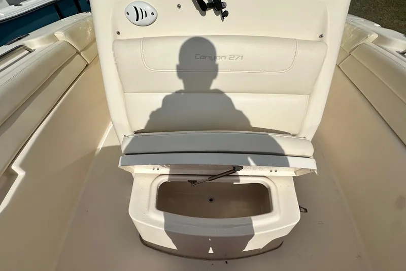 Slide: The Image of 2020 Grady-White Canyon 271 boat seat with storage compartment open. - 25