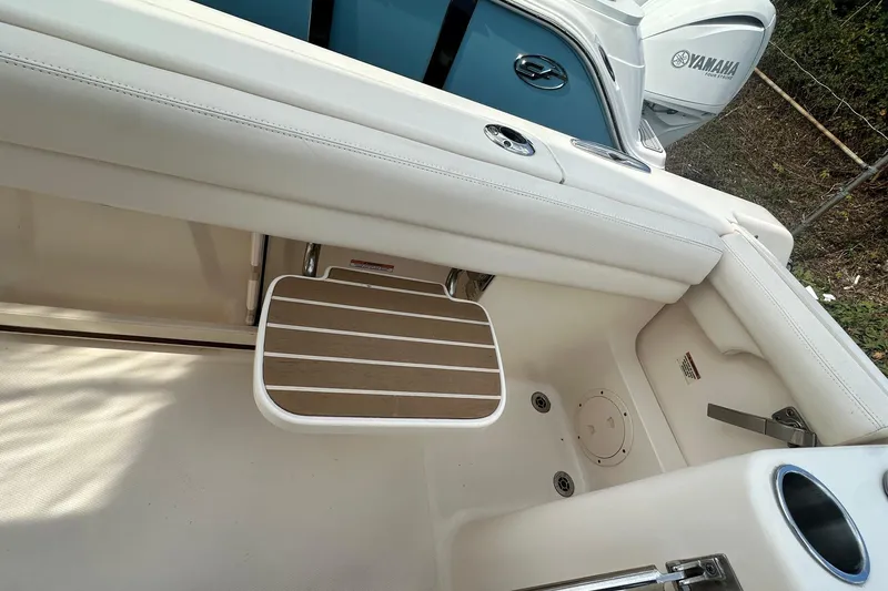 Slide: The Image of 2020 Grady-White Canyon 271 boat interior with Yamaha engine, featuring a foldable seat. - 7