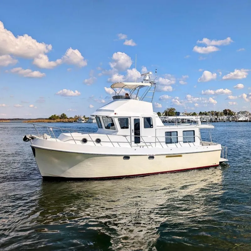 The Image of 2015 American Tug 435 cruising on a sunny day with blue skies and calm waters. - 0
