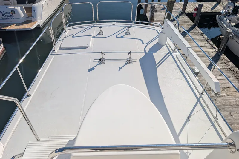 Slide: The Image of American Tug 435 (2015) boat deck with railings, docked at marina. - 17