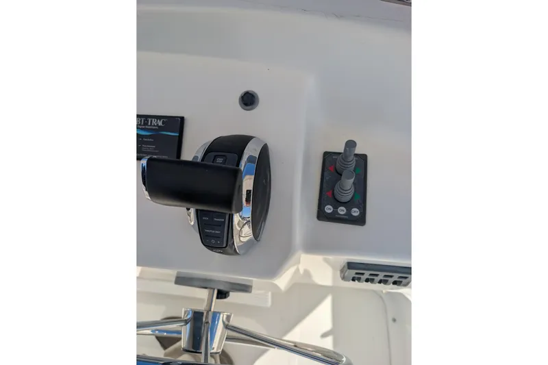 Slide: The Image of Control panel of a 2015 American Tug 435 boat, featuring throttle and joystick controls. - 22