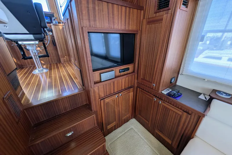 Slide: The Image of Interior of 2015 American Tug 435 with wood paneling and built-in TV. - 30