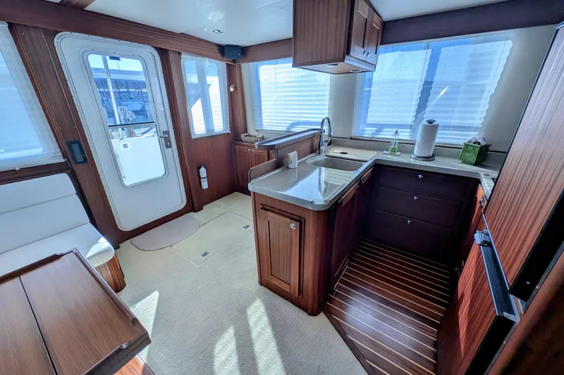 Slide: The Image of Luxurious interior of 2015 American Tug 435 with modern kitchen and elegant wood finishes. - 31