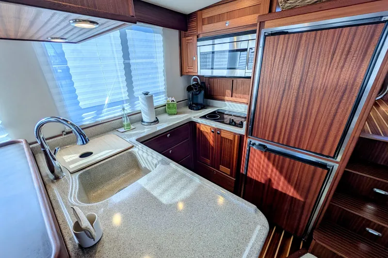 Slide: The Image of Luxurious 2015 American Tug 435 kitchen with modern appliances and elegant wood cabinetry. - 35