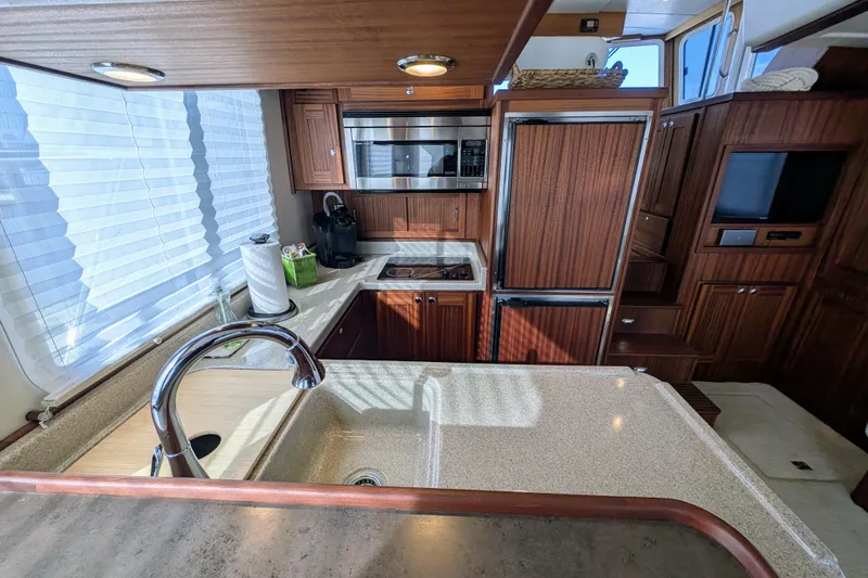 Slide: The Image of Luxurious kitchen interior of 2015 American Tug 435 with modern appliances and wood cabinetry. - 36
