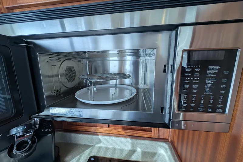 Slide: The Image of Open microwave oven in 2015 American Tug 435 kitchen, with control panel and Keurig coffee maker nearby. - 41