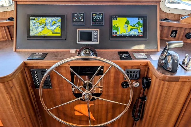 Slide: The Image of American Tug 435 helm, 2015 model, featuring navigation screens and controls. - 42