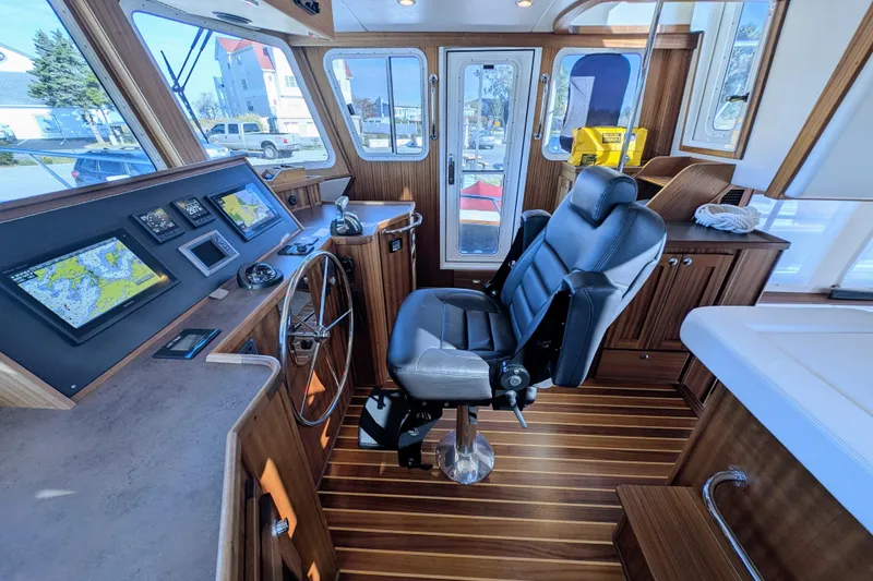 Slide: The Image of Pilothouse of 2015 American Tug 435 with navigation screens and captain's chair. - 44