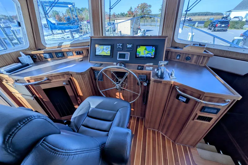 Slide: The Image of Pilothouse of 2015 American Tug 435 with navigation screens and wooden interior. - 45