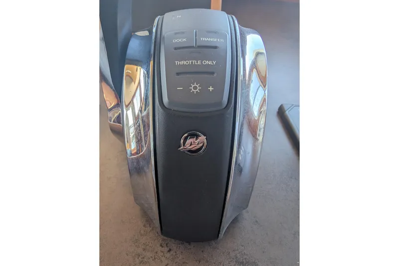 Slide: The Image of Throttle control panel of a 2015 American Tug 435 boat, featuring dock and transfer buttons. - 47