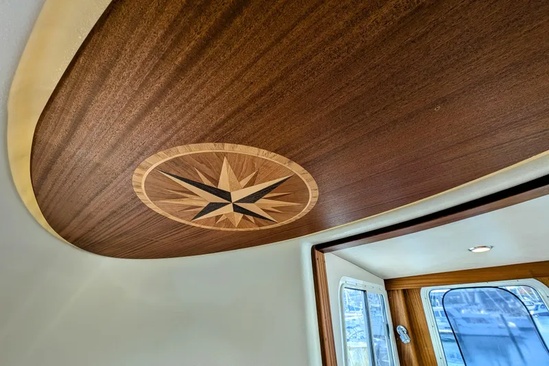 Slide: The Image of Wooden interior ceiling with compass rose design on 2015 American Tug 435 boat. - 50