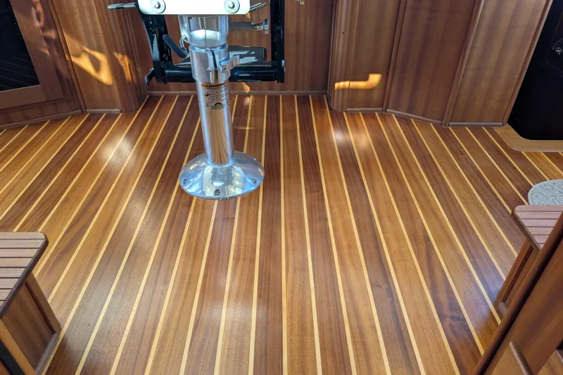 Slide: The Image of Polished wooden interior flooring of a 2015 American Tug 435 boat. - 52