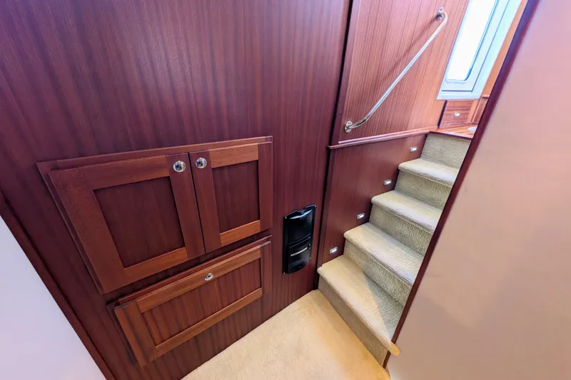 Slide: The Image of Interior of 2015 American Tug 435 with wooden cabinetry and carpeted stairs. - 59