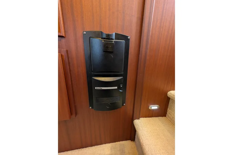 Slide: The Image of Built-in vacuum system on 2015 American Tug 435 yacht, mounted on wooden wall near stairs. - 60