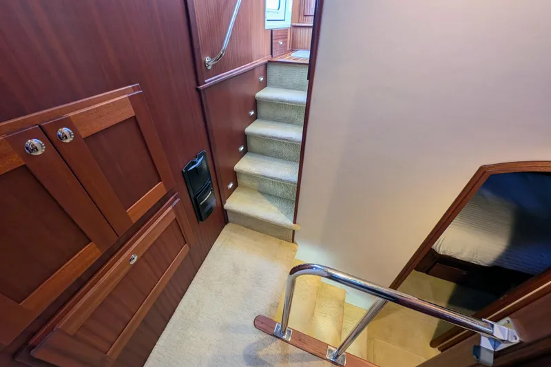 Slide: The Image of Staircase and cabin interior of 2015 American Tug 435 yacht, featuring wood paneling. - 61
