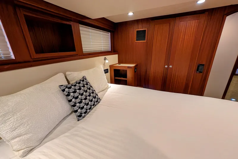 Slide: The Image of Luxurious cabin interior of 2015 American Tug 435 with wood paneling and cozy bedding. - 68