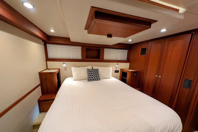 Slide: The Image of Luxurious cabin interior of 2015 American Tug 435 with wood accents and cozy bed. - 69