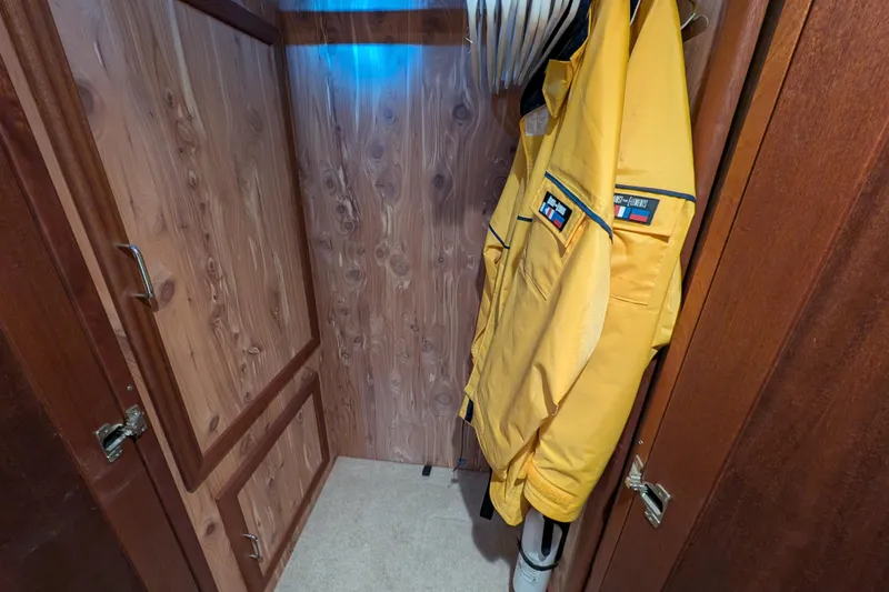 Slide: The Image of Wooden closet with yellow jacket on hanger, inside 2015 American Tug 435 boat. - 72