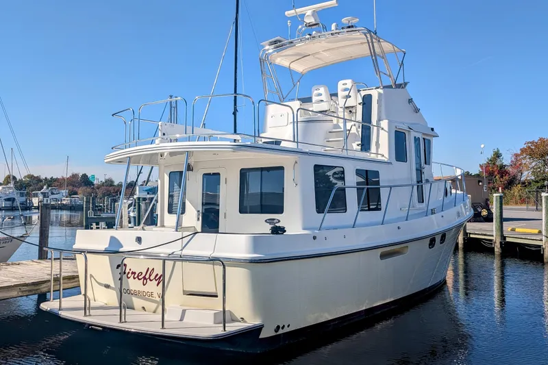 Slide: The Image of 2015 American Tug 435 docked at marina, clear sky, calm water. - 9