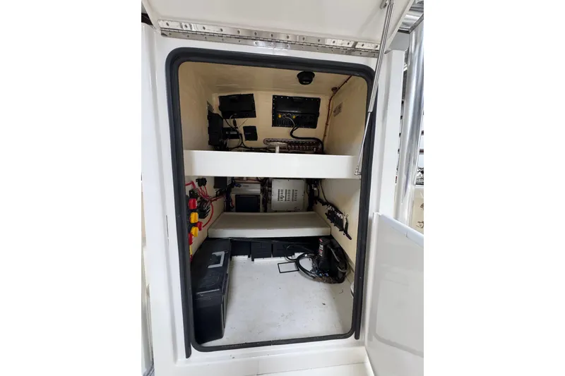Slide: The Image of 2018 Calcutta catamaran interior showing electrical components and storage space. - 12