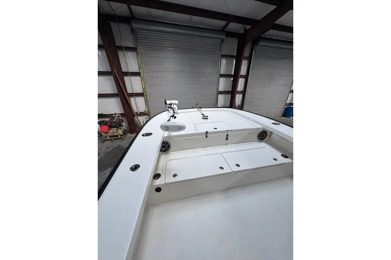 Slide: The Image of 2018 Calcutta catamaran interior with storage compartments in a garage setting. - 2