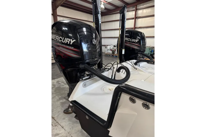 Slide: The Image of 2018 Calcutta catamaran with Mercury four-stroke engines in a warehouse setting. - 23