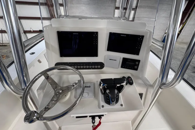 Slide: The Image of 2018 Calcutta catamaran helm with dual Simrad displays and Mercury controls. - 6