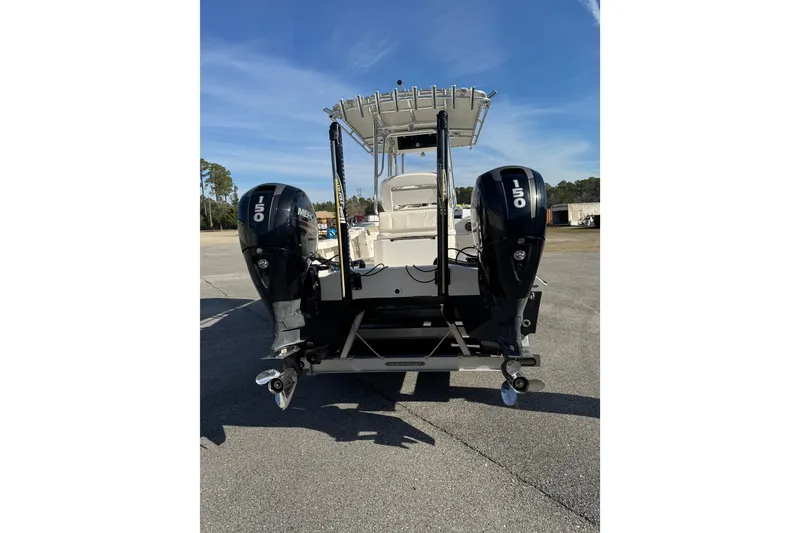 Slide: The Image of 2018 Calcutta catamaran with dual Mercury 150 engines, parked on pavement. - 8