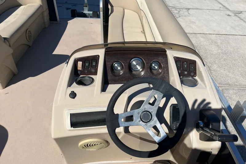 Slide: The Image of 2014 Bennington 22SSX boat dashboard with steering wheel and control panel. - 11