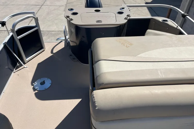 Slide: The Image of 2014 Bennington 22SSX boat interior with seating and storage compartments. - 12